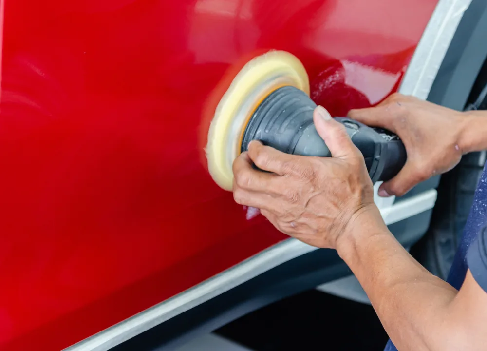 Machine paint correction on a red performance car